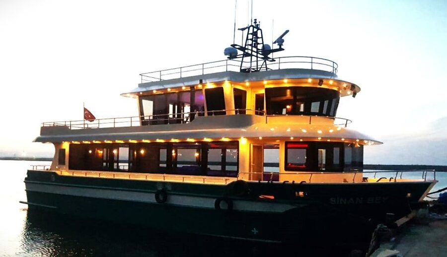 Istanbul: Bosphorus Sunset Cruise with Dinner - Dolmabahçe Palace at night, ending with sweets and DJ energy